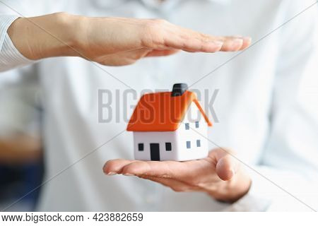 Women Hands Save House With Roof Concept