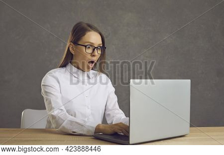 Portrait Of Young Shocked Astonished Businesswoman Woman Working On Laptop