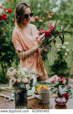 Woman arranging flowers in a garden