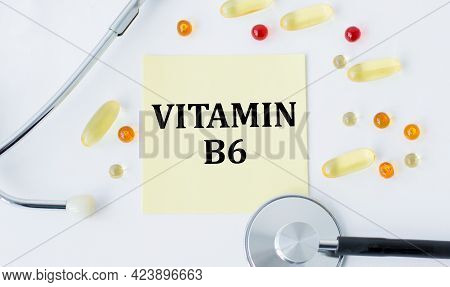 Medical Concept, Stethoscope, Pills And Yellow Card With Text Vitamin B6 On White Background