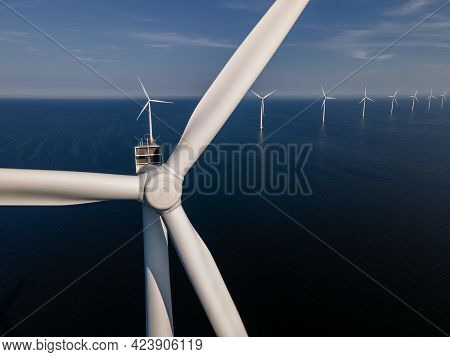 Wind Turbine From An Aerial View, Drone View At Windpark A Windmill Farm In The Lake Ijsselmeer The 
