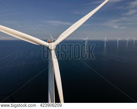 Wind Turbine From An Aerial View, Drone View At Windpark A Windmill Farm In The Lake Ijsselmeer The 