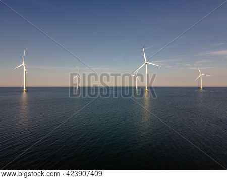 Wind Turbine From An Aerial View, Drone View At Windpark A Windmill Farm In The Lake Ijsselmeer The 