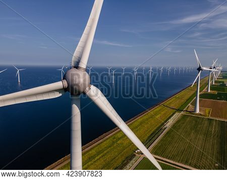 Wind Turbine From An Aerial View, Drone View At Windpark A Windmill Farm In The Lake Ijsselmeer The 