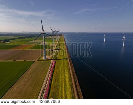 Wind Turbine From An Aerial View, Drone View At Windpark A Windmill Farm In The Lake Ijsselmeer The 