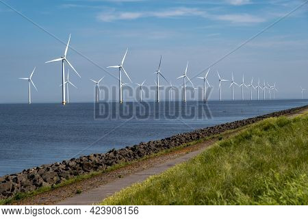Wind Turbine From An Aerial View, Drone View At Windpark A Windmill Farm In The Lake Ijsselmeer The 
