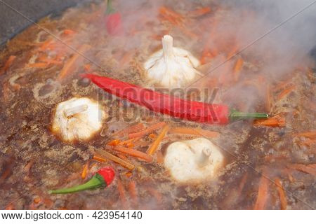 Boiling Carrots, Garlic, Red Pepper For Pilaff