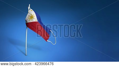 Philippinian Mask On Dark Blue Background. Waving Flag Of The Philippines Painted On Medical Mask On