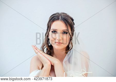 Brunette Girl In A Wedding Dress. Bride In A White Dress. Makeup.