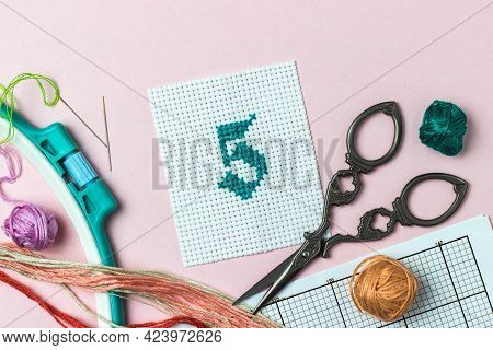 Green Number 5 Cross-stitch Embroidered Surrounded By Accessories For Embroidery: Threads Of Moulin 
