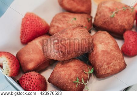 Traditional French Beignets Doughnuts With Strawberry And Powdered Sugar.