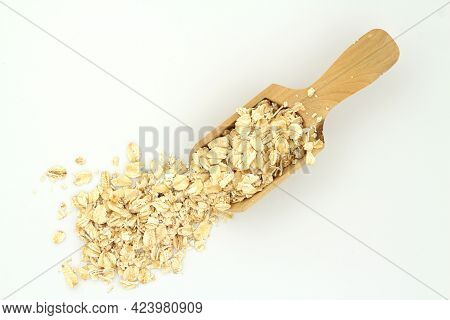 Oat Flakes In Wooden Spoon Isolated On White Background. Heap Of Oats For Package Of Oatmeal Or Gran