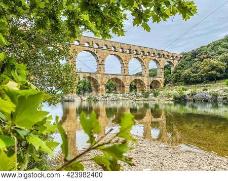 Roman aqueduct seen through foliage, Pont-du-Gard, Languedoc-Roussillon France