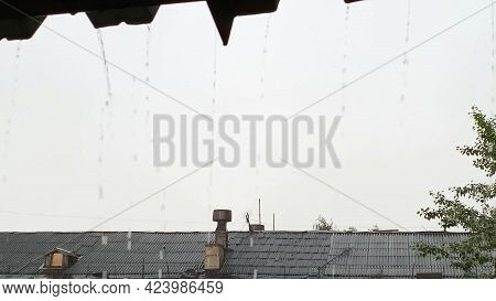 Raining Outside. Roof View. Grey Sky. Water Pouring From Housetop.