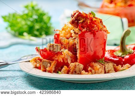 Stuffed Peppers With Tofu, Rice And Vegetables Are Served In A Plate With Tomato Sauce. Concept Is T