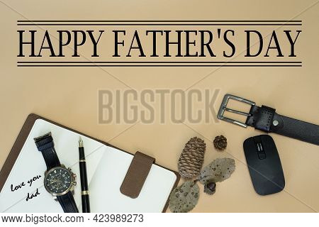 Happy Father\\\'s Day Concept With Belt, Mouse, Dried Pine Cones And Leaves, Pen, Wristwatch, Notebo