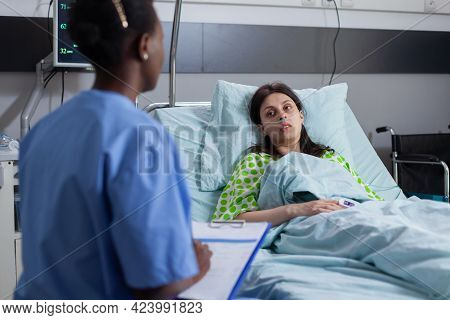 Black Afro-american Asisstant Discussing With Patient Monitoring Illness Symptom Writing Disease Tre