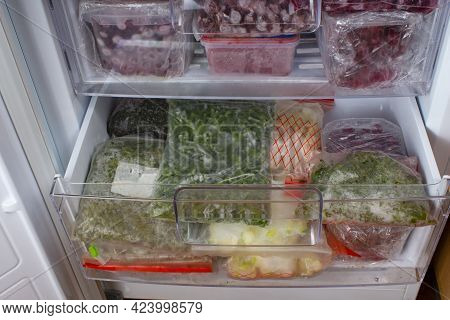Open Freezer With Frozen Red Cherries And Frozen Vegetables. Food Storage. Deep-frozen Food. Food Su