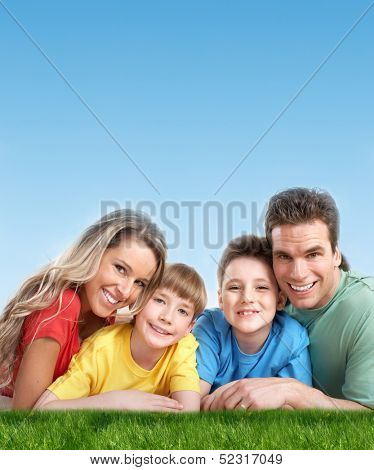 Happy family with two kids relaxing in park.