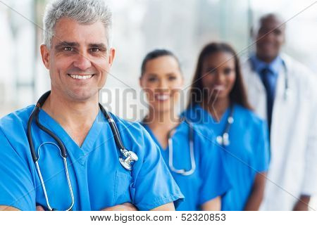 handsome senior medical doctor and team at hospital