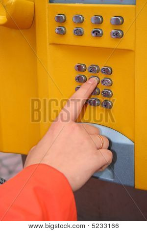 Woman Is Using The Public Telephone