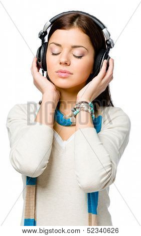 Half-length portrait of teenager with eyes closed listening to music in earphones, isolated on white