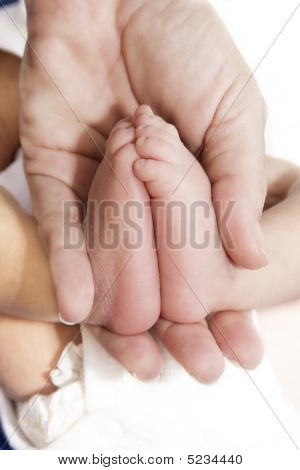Adult´s Hand And Baby´s Foot