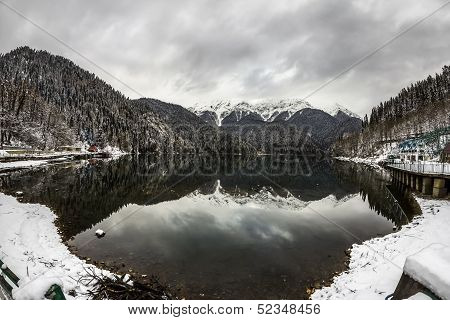 Alpine Lake Ritsa In Winter Under Gloomy Clouds, Abkhazia