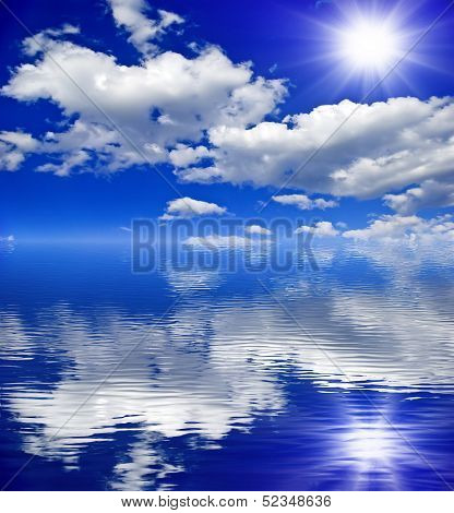 The Sun,the Clouds In The Blue Sky Reflected In The Water.