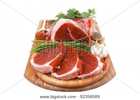 uncooked meat : raw fresh beef pork rib and fillet ready to cooking with garlic and green stuff over wood isolated on white background