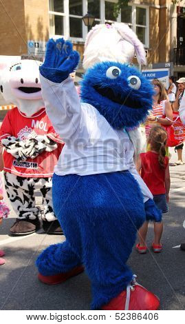 GRANBY, QUEBEC, CANADA- JULY 22: Mascot Festival in Granby, Quebec. Five day Annual family event with a Mascot parade. Poilu the mascot meets  people in the street on July 22, 2012 in Granby, Quebec, Canada