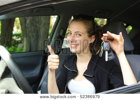 Happy teenager having key car in hands
