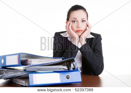 Sad woman with ringbinders sitting at the desk. Tired and exhousted business woman. 