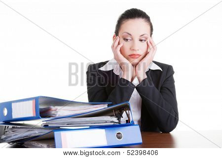 Sad woman with ringbinders sitting at the desk. Tired and exhousted business woman. 