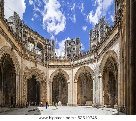 Batalha, Portugal - July 17, 2013: Tourists stroll around the interior of the Unfinished Chapels - Capelas Imperfeitas of the Batalha Monastery. UNESCO World Heritage Site.