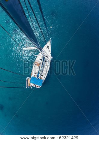Young couple relaxing on board of the sail boat anchored in shallow tropical bay