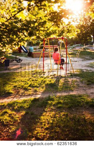 Girl on a swing in the Playground