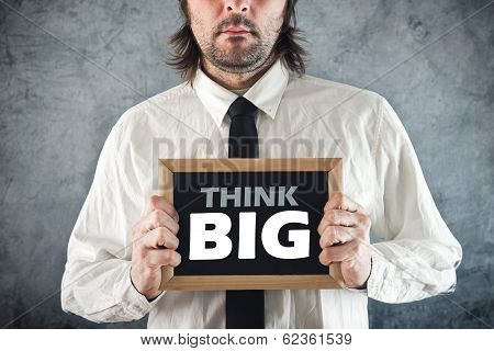 Businessman Holding Blackboard With Think Big Title