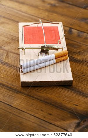 Mousetrap with cigarette, isolated on white