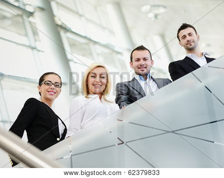 Group of businesspeople standing together in modern office