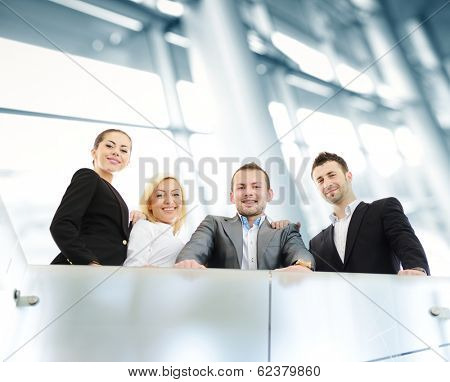 Group of businesspeople standing together in modern office