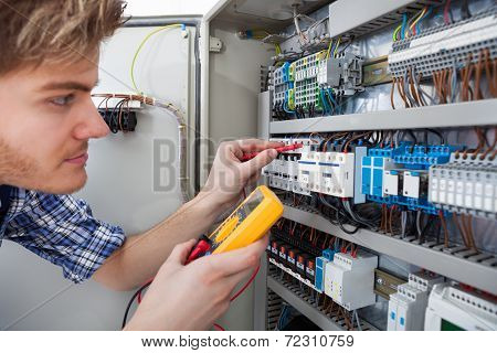Technician Examining Fusebox With Insulation Resistance Tester