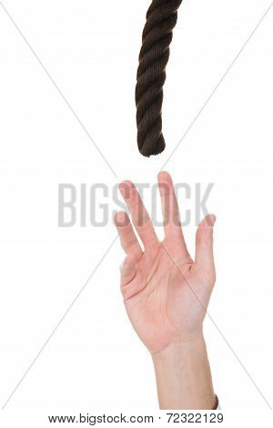 Businessman's Hand Trying To Reach Rope