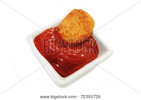 Fish Or Chicken Nugget Dipped In A Condiment Over White