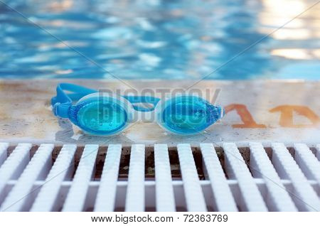 Blue goggles by the pool