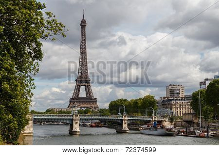 Seine River In Paris, With The Eiffel Tower In The Background.