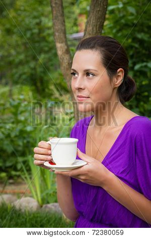 Beautiful Young Woman Drinking Coffee Outdoors