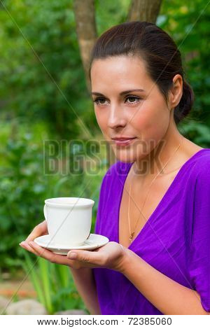 Beautiful Young Woman Drinking Coffee Outdoors
