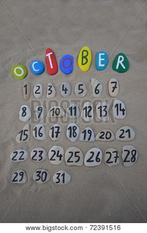 October calendar on stones with sand background