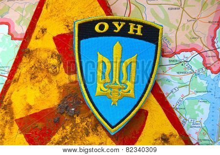 Kiev,Ukraine.JAN 10: Chevron of Ukrainian Nationalist Organisation -OUN,with sign Radioactive and Chernobyl area as background. At January 10,2015 in Kiev, Ukraine